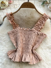 Pink ruffled crop top with smocked bodice and eyelet trim detail