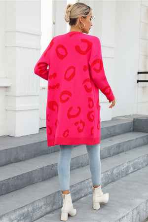 Hot pink knit cardigan with red leopard motif, long sleeves, and pockets.
