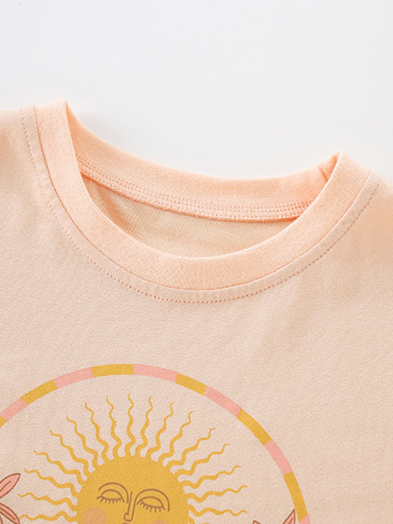 Toddler apricot cotton tee with sun graphic and round neckline