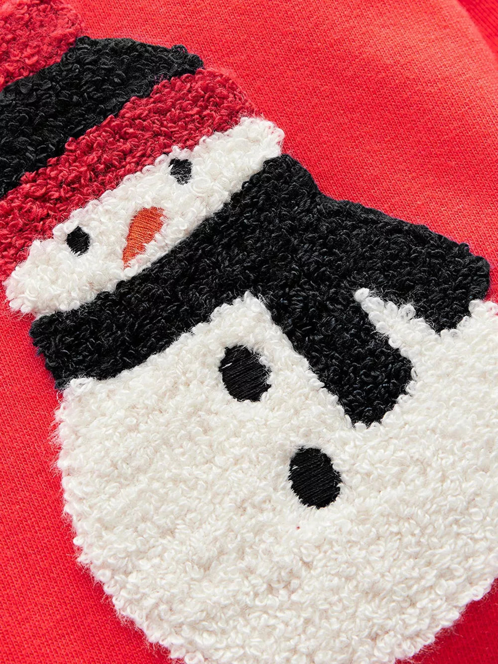Red sweatshirt with a textured snowman applique featuring a black hat and scarf.