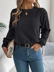 Black openwork knit sweater with crew neck and long sleeves.