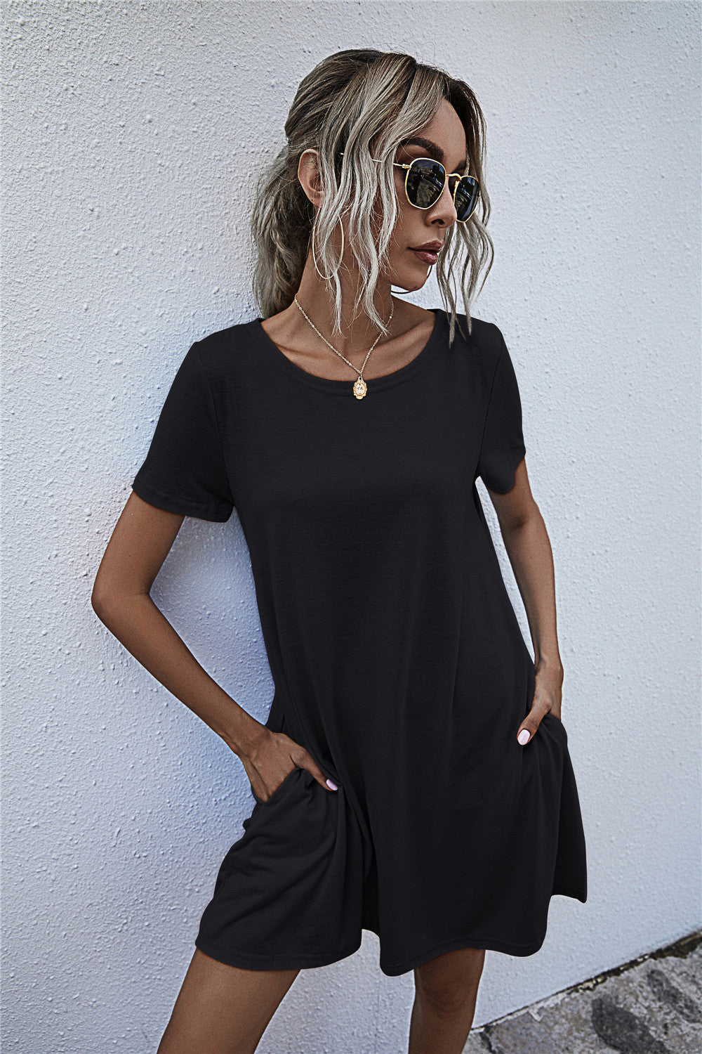 Black relaxed tee dress with short sleeves and side pockets