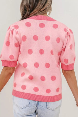 Pink polka dot knit cardigan with puff sleeves and ribbed trim.