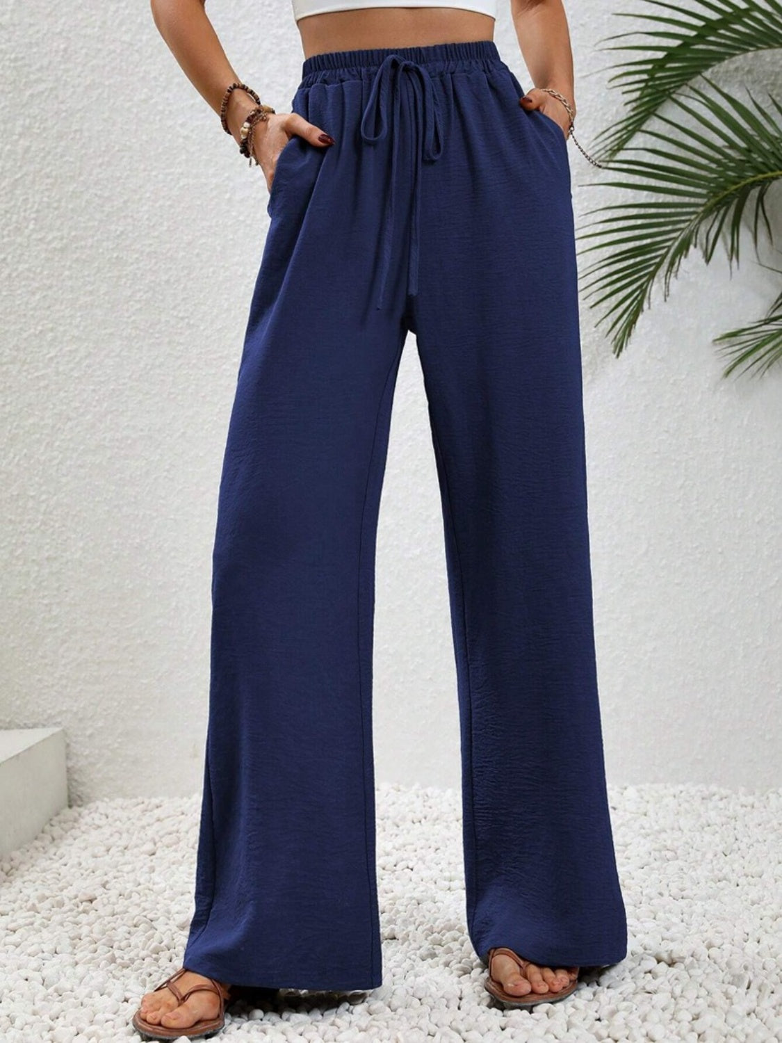 Dark blue textured palazzo trousers with drawstring waist and pockets