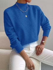 Blue mock neck knit sweater with dropped shoulders and ribbed cuffs.