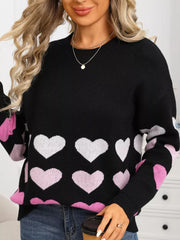 Black crew neck sweater with allover heart print in pink and white, acrylic knit.