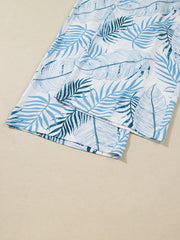 Tropical leaf print wide leg pants in white with blue foliage pattern, cotton.