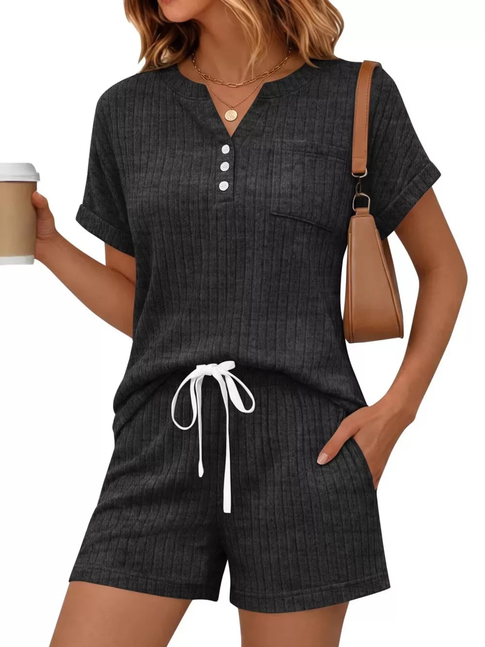 Chic ribbed knit loungewear set in black, featuring a henley top with pocket and drawstring shorts.