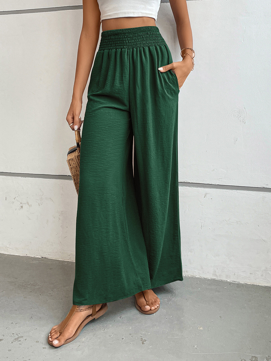 Textured palazzo lounge trousers in dark green with smocked waist and wide legs.