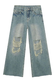 Distressed wide-leg jeans in medium wash denim with frayed rips on the knees.