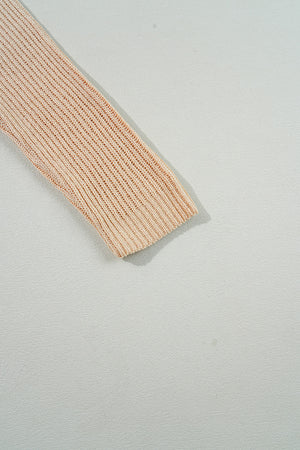 Tan ribbed knit pullover sweater sleeve with asymmetric hem detail