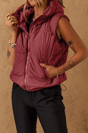 Burgundy quilted hooded puffer vest with zip front and adjustable drawcord hem.