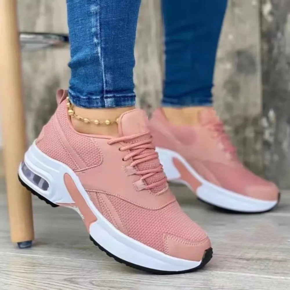 Pink lace up air cushion sneakers with white chunky sole and visible air bubble detail.
