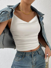 White cowl neck cami with ruched sides, styled with a denim jacket.