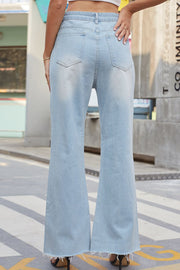 Light wash denim flare jeans with distressed knees and raw hem.