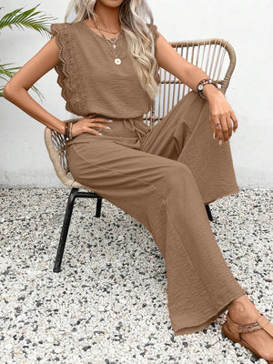 Taupe textured ruffle sleeve drawstring jumpsuit with wide leg pants.