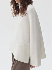 Ivory ribbed turtleneck sweater with flared sleeves and a ribbed hem detail.