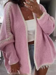 Oversized pink cardigan with cream contrast trim and frayed hem.