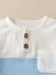 Children's color-block cotton top with two wooden buttons and a chest pocket.