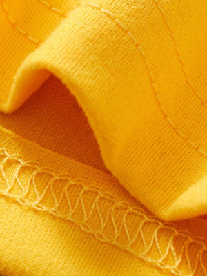 Yellow toddler tee and shorts set fabric detail with zigzag stitching.