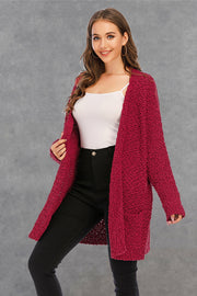 Burgundy textured cocoon cardigan with patch pockets and open front.