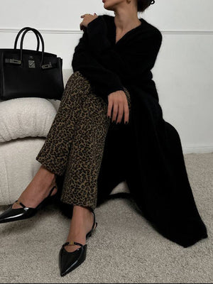 Black plush maxi cardigan with balloon sleeves, styled with leopard print pants and black slingback flats.