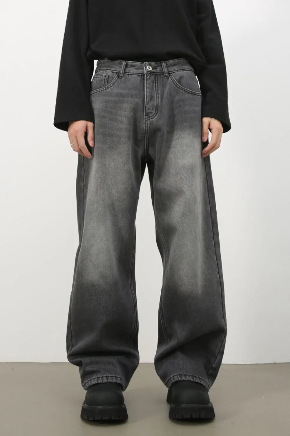 Faded dark gray cotton denim jeans with a wide-leg silhouette.