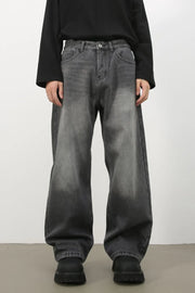 Faded dark gray cotton denim jeans with a wide-leg silhouette.