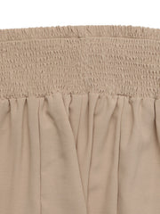Smocked waist wide leg trousers in beige cotton with a relaxed fit.