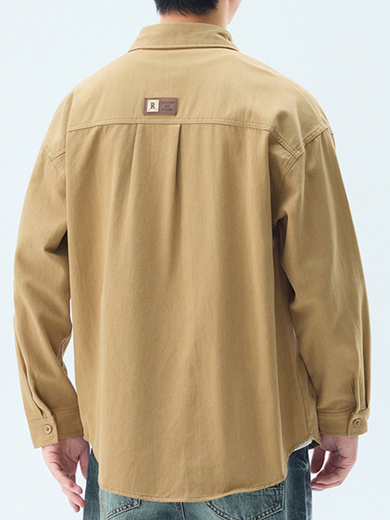 Men's mustard cotton casual button-up shirt with back pleats and a logo patch.