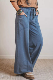 Maternity wide-leg jeans in blue denim with drawstring waist and pockets.