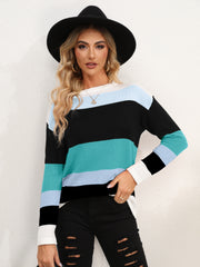 Colorblock crewneck sweater with teal, light blue, black, and white stripes.