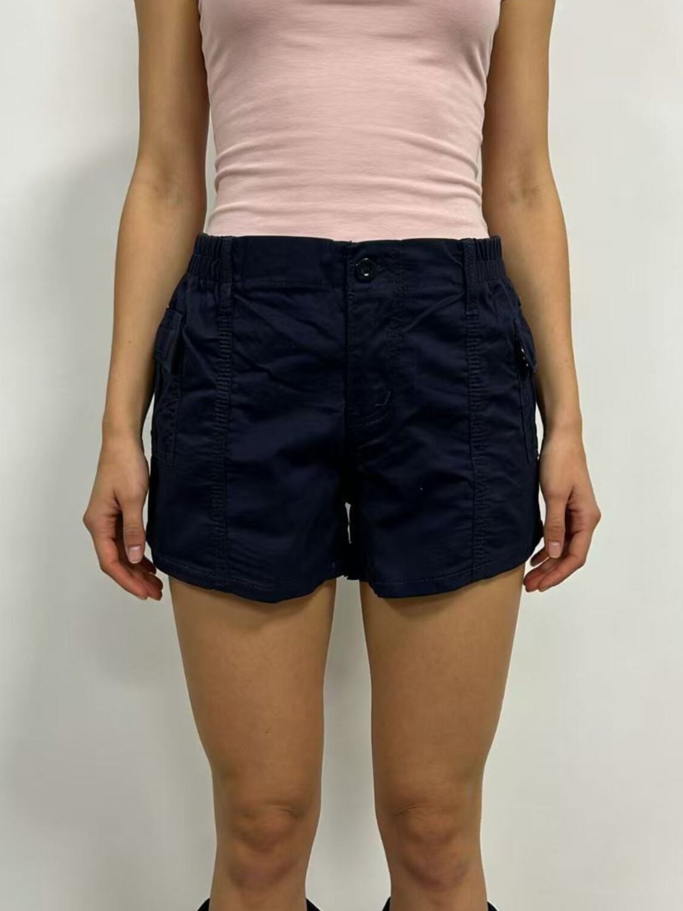 Navy cargo shorts with button closure and multiple pockets.