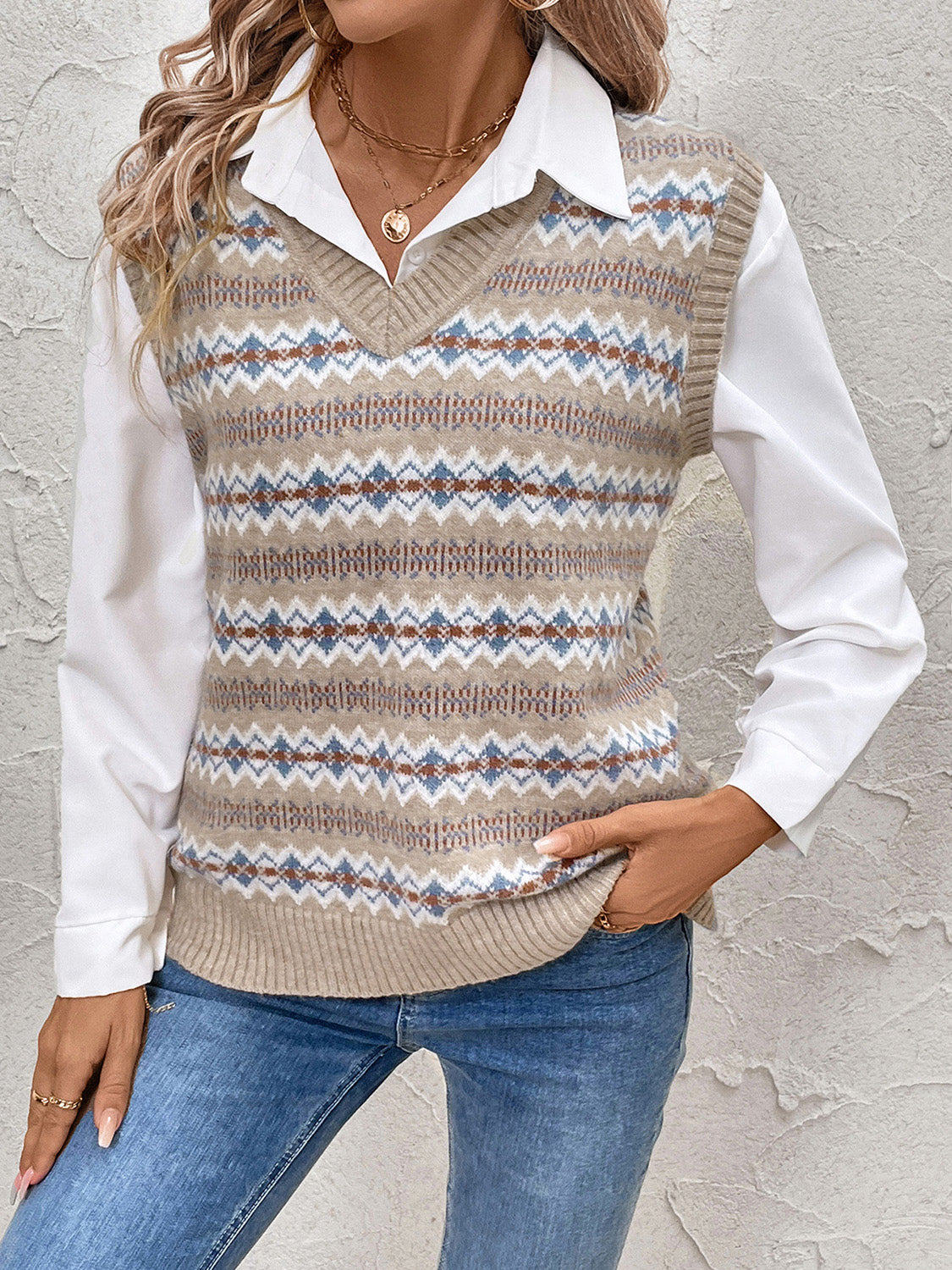 Mocha geometric knit v-neck vest with a fair isle pattern, styled over a white collared shirt.