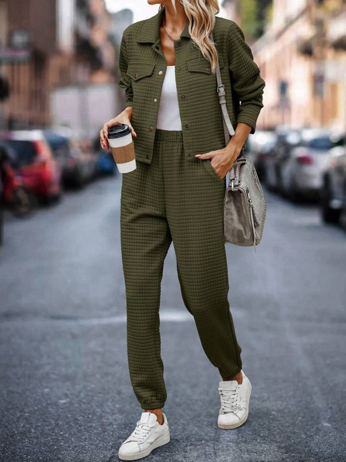 Army green quilted co-ord jacket and joggers set with a white tank top and sneakers.