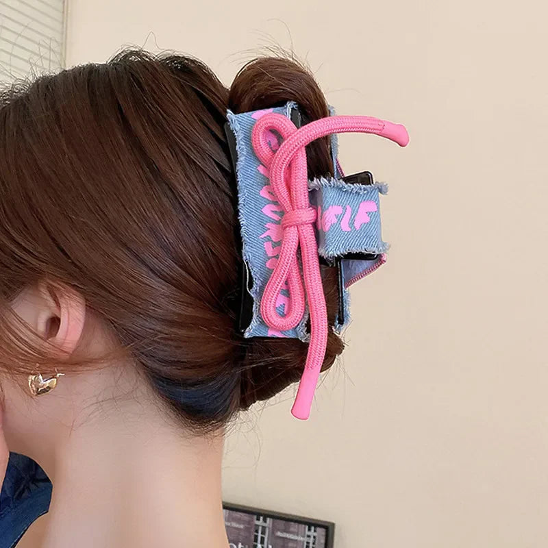 Denim patchwork claw clip with pink drawcord detail.