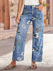 Light blue denim wide-leg jeans with a floral print and embellishments.