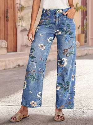 Light blue denim wide-leg jeans with a floral print and embellishments.