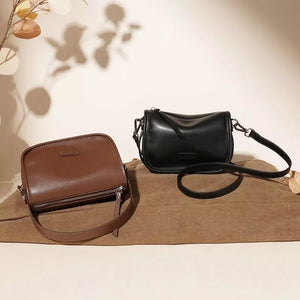 Sleek leather crossbody bags in caramel and black with adjustable straps.