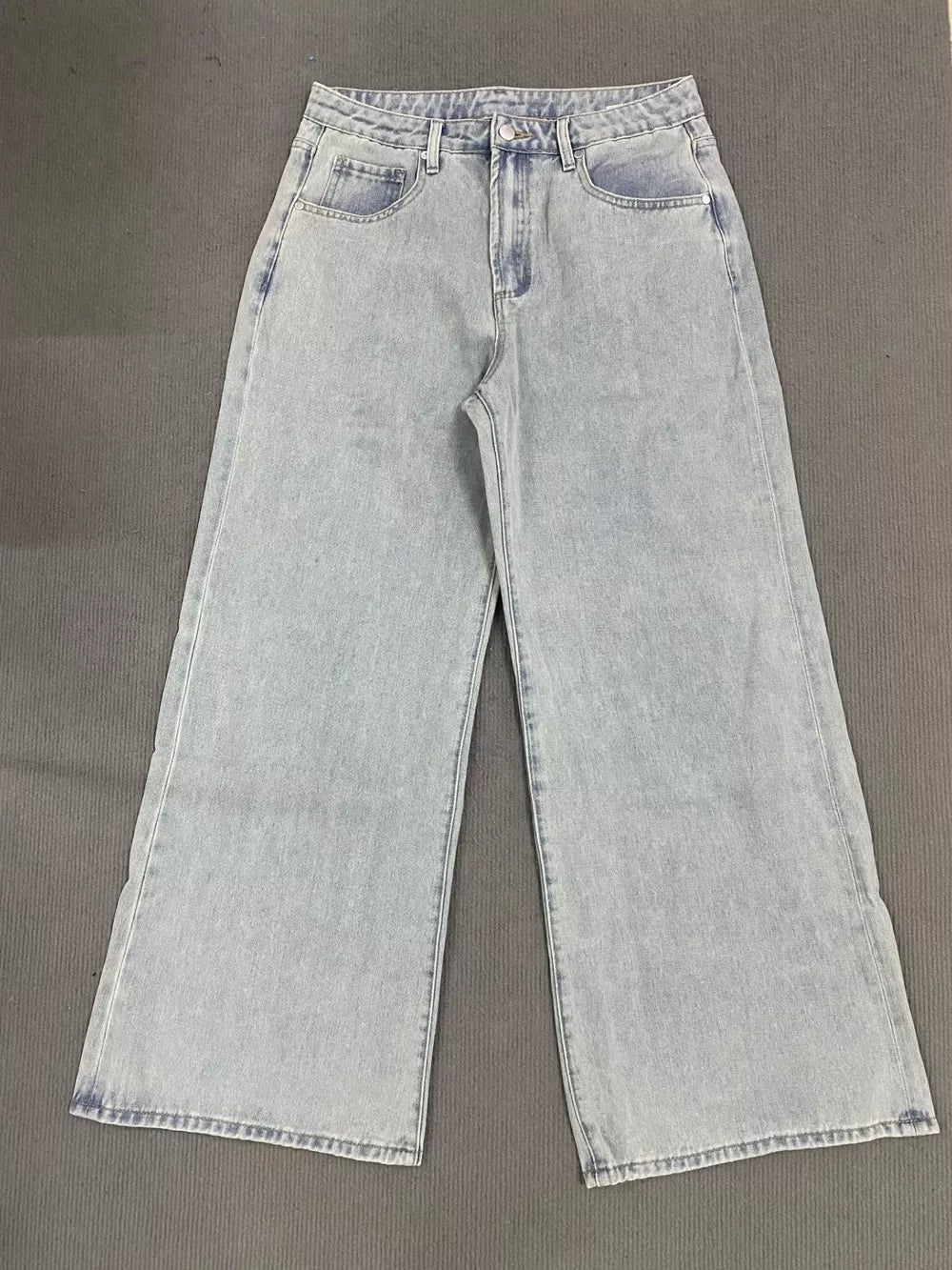 Light wash denim high-waisted relaxed fit jeans with button fly and wide leg.