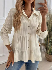 Cream textured tiered button-down shirt with crinkled fabric and button details.