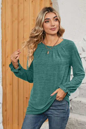 Teal knit top with pleated yoke and ruffled cuffs, crew neck, long sleeves.