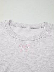 Gray crewneck sweatshirt with pink bow embroidery