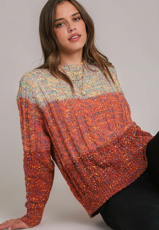 Ombre cable knit crewneck sweater in orange-red with a textured flecked yarn and a relaxed fit.