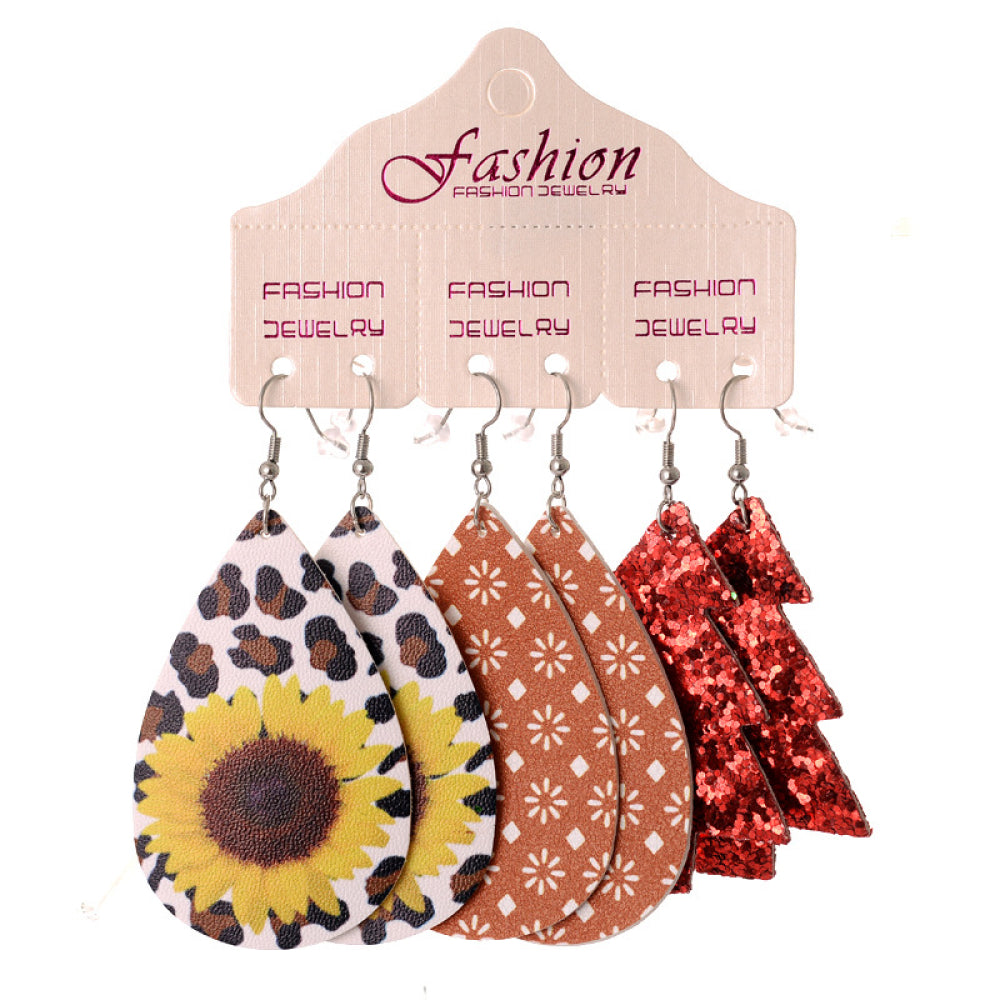 Festive drop earrings trio set with sunflower, geometric, and glitter tree designs.