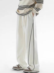 Men's white relaxed fit sweatpants with black side stripes and drawstring waist.