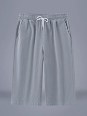 Light gray relaxed fit cropped sweatpants with drawstring waist and pockets