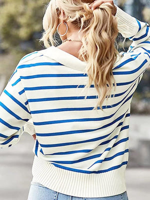 Striped polo knit sweater in cream with royal blue stripes, featuring a relaxed fit and ribbed cuffs.