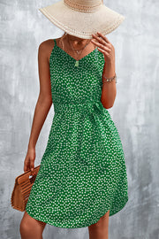 Green daisy print slip dress with tie waist and V-neck