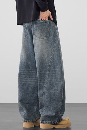 Men's oversized wide-leg jeans in medium wash denim with a relaxed fit.